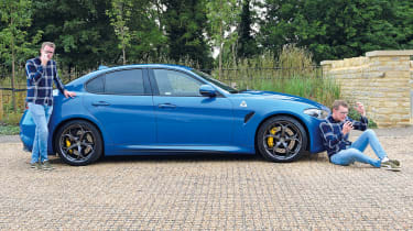 Two Sean Carsons standing with the Alfa Giulia